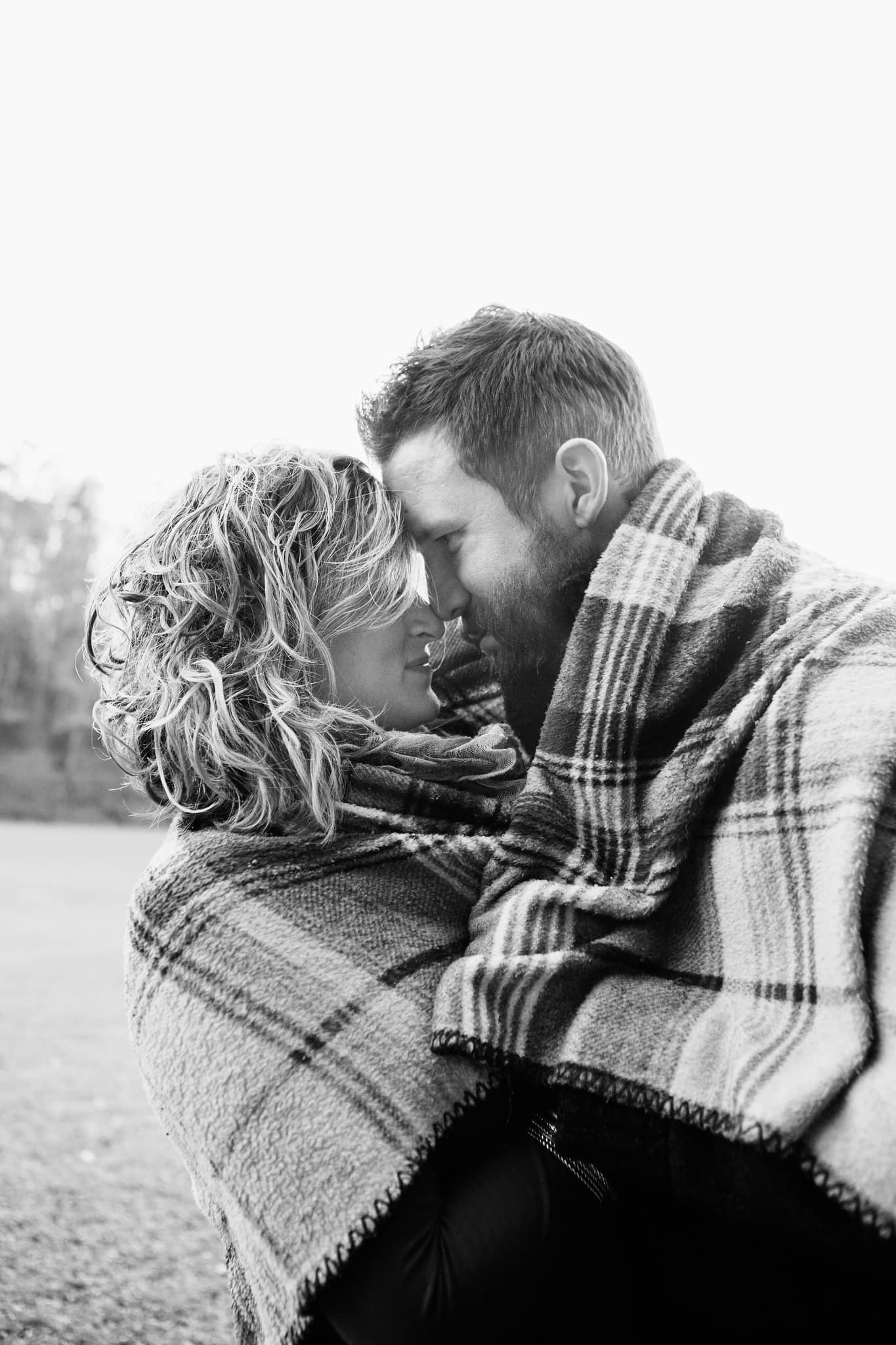 Couple cudding wrapped in blanket