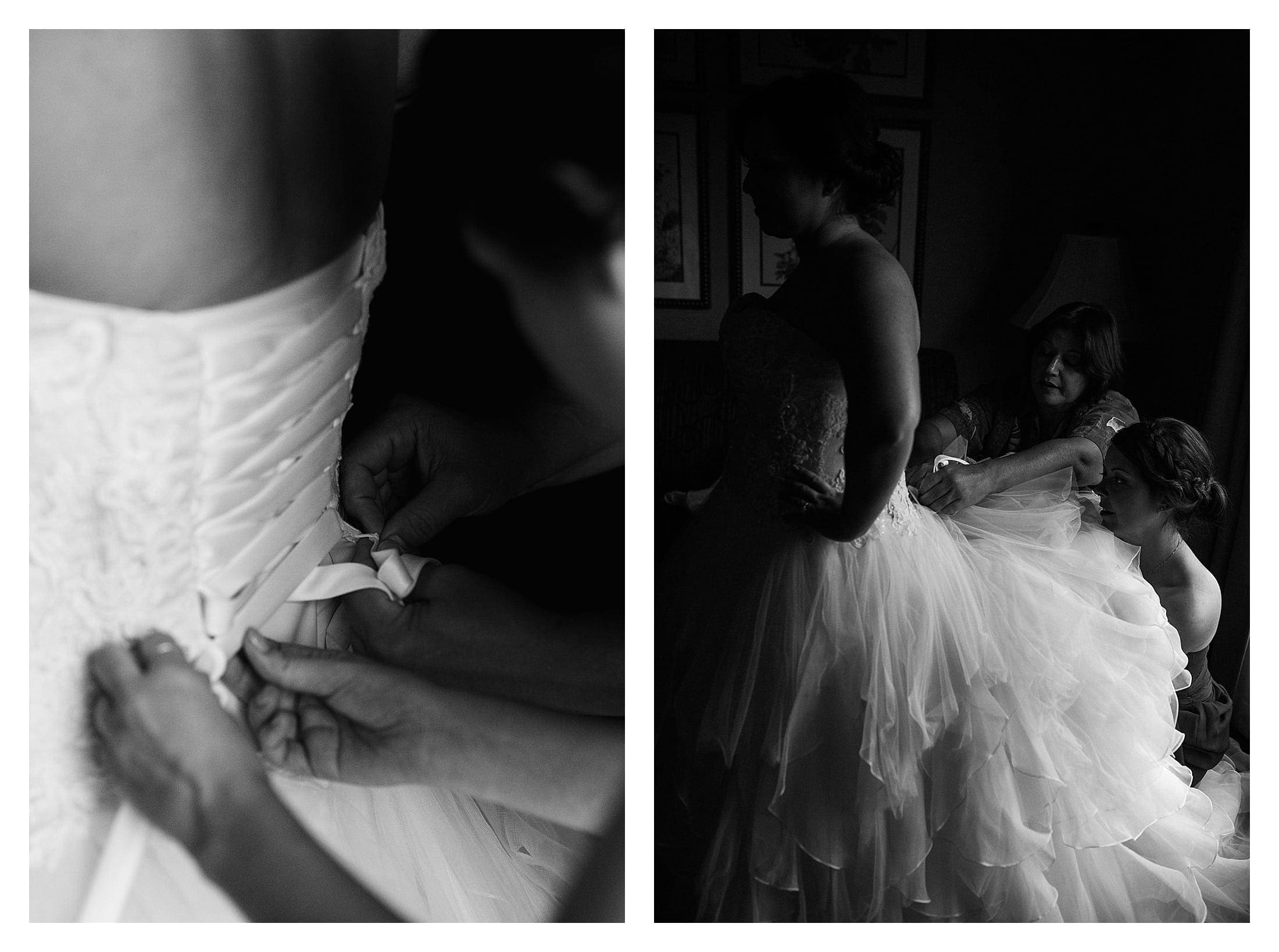 black and white photography of bride getting into her wedding dress